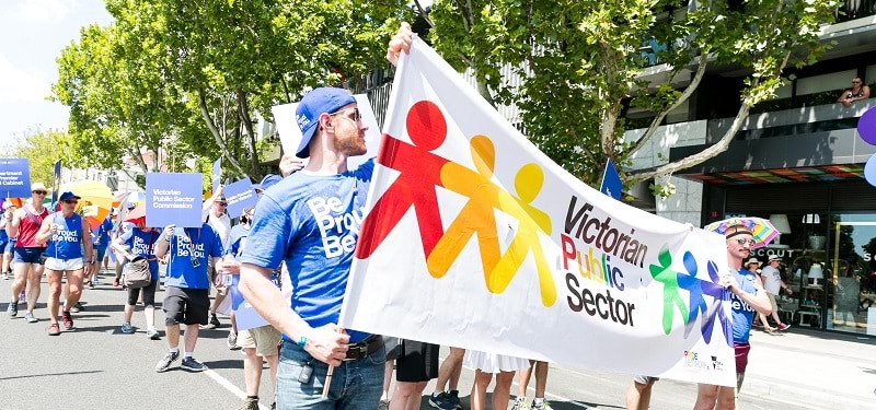 Members of the VPS Pride Network marching with a banner