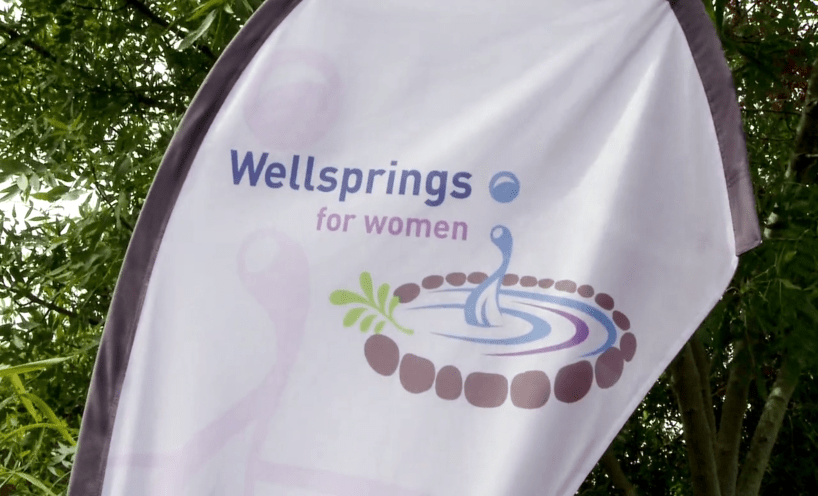 Wellsprings for Women logo on flag outside