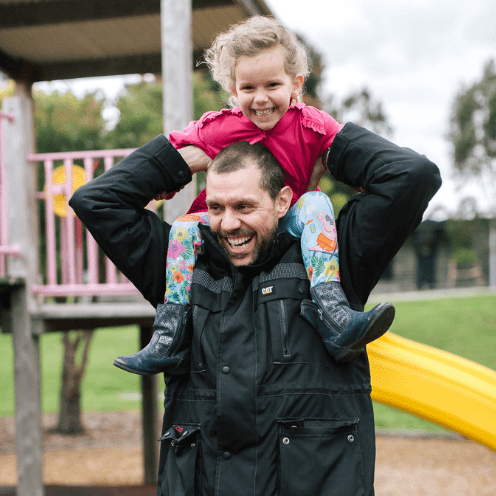 Man with child on shoulders. 