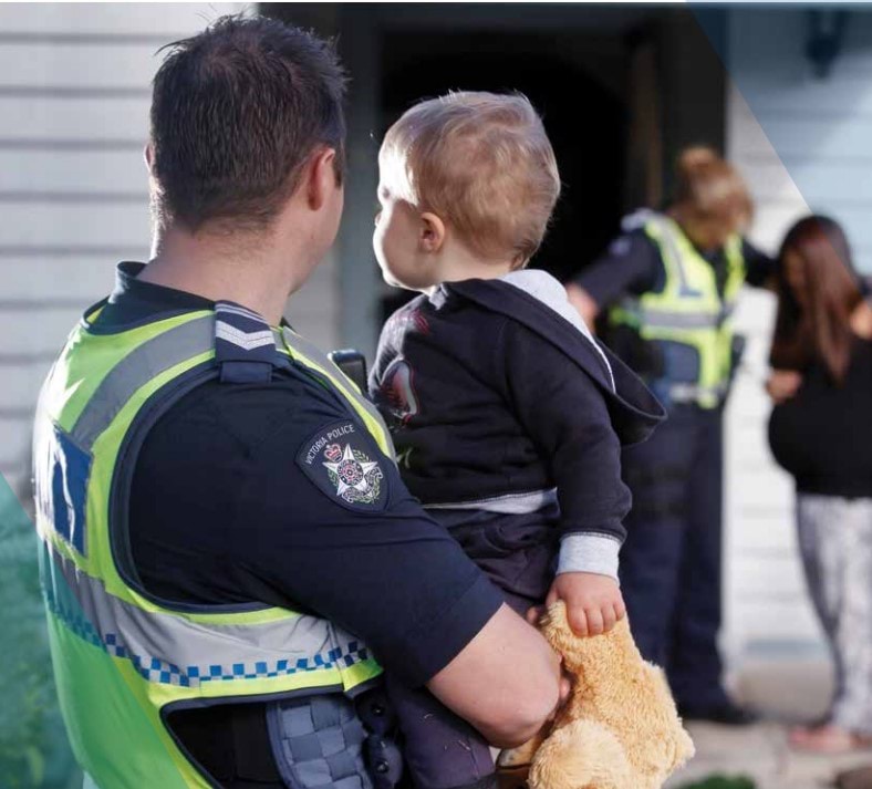 Police officer carrying a child