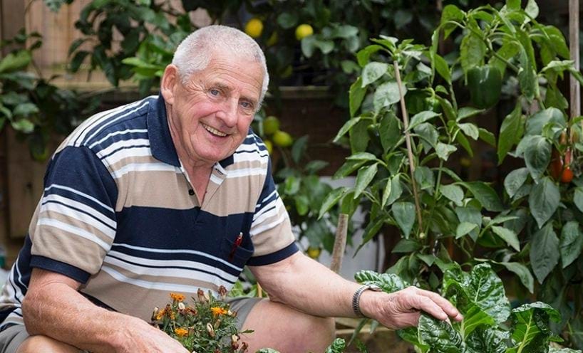 Man kneeling down in garden