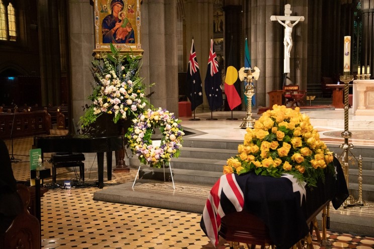 Bert’s coffin was draped in an Australian flag, with yellow roses placed atop