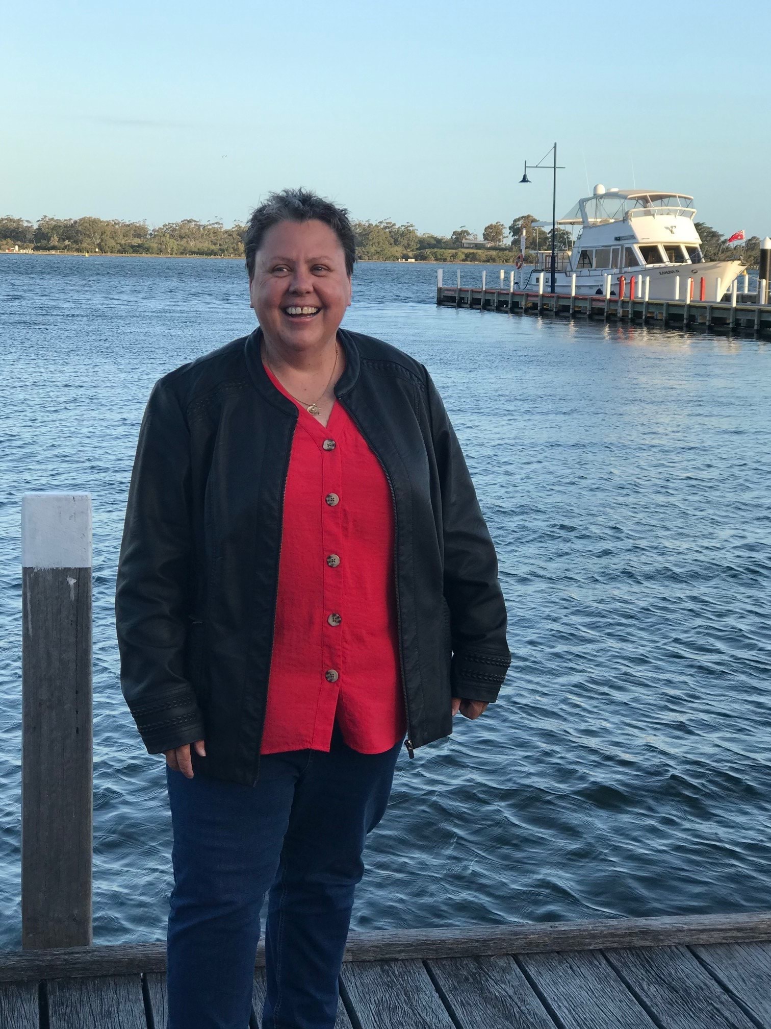 Leonie Cooke standing and smiling next to the sea