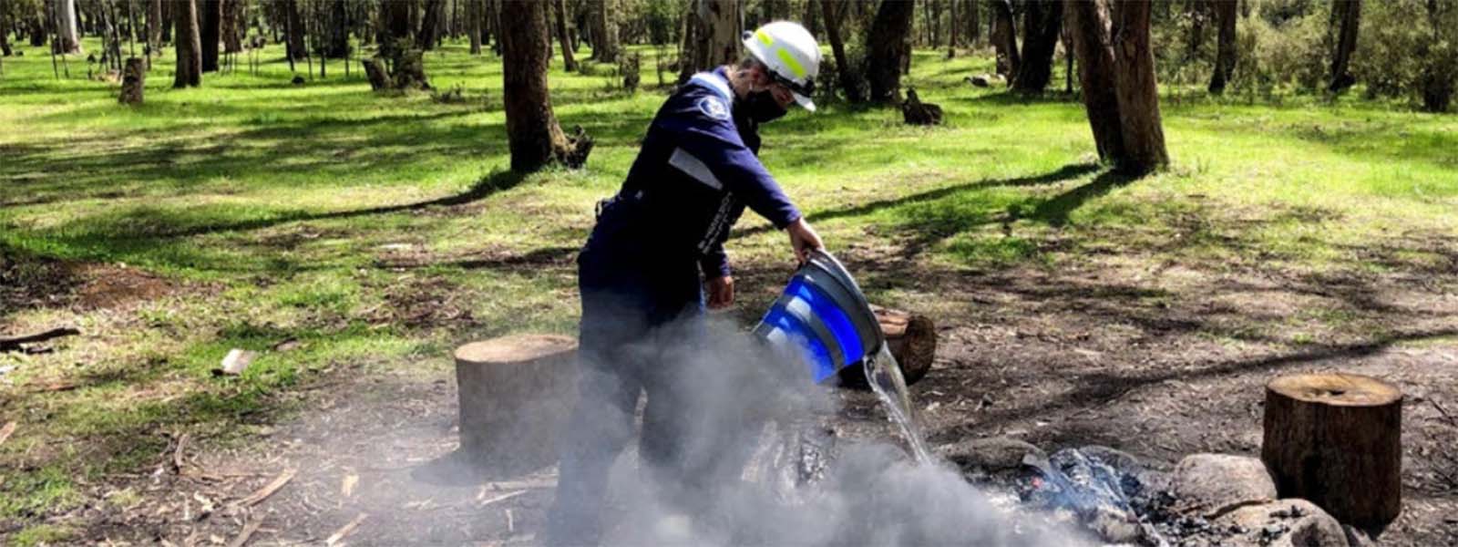 Officer putting out an unextinguished and illegal campfire