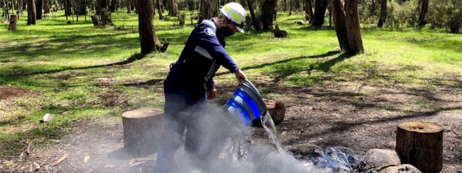 Image of regulatory officer extinguishing an illegal campfire