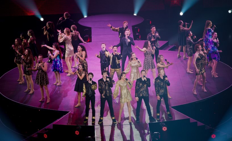 Group of vocalists performing onstage