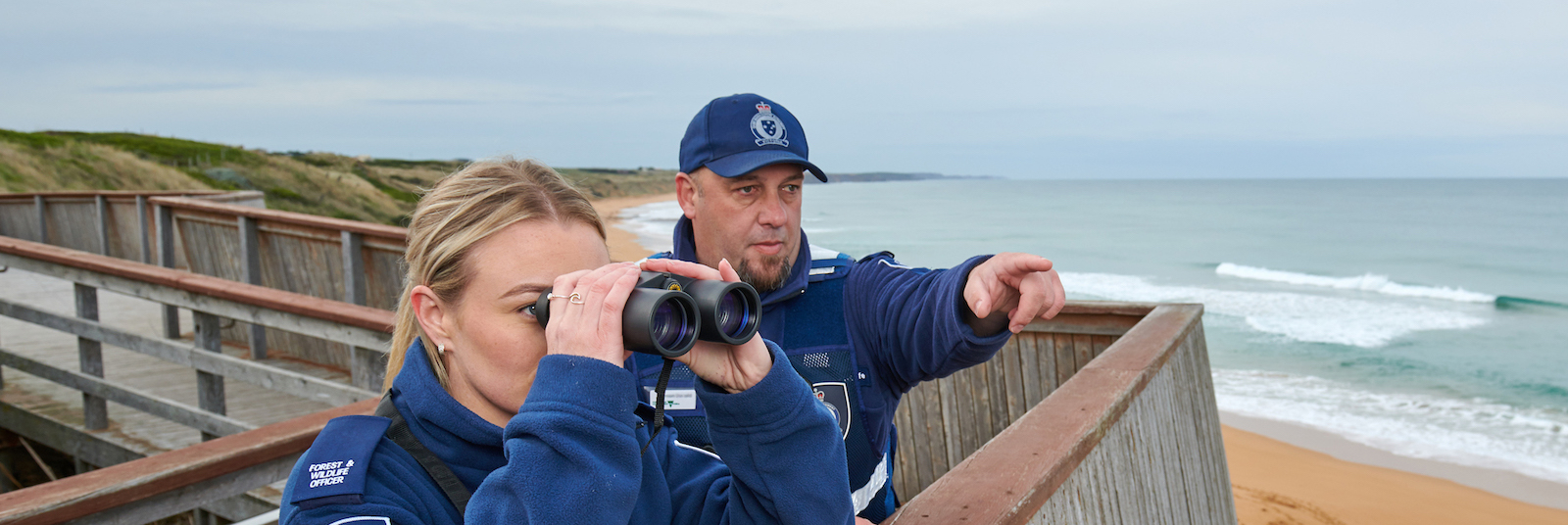 Image of officers looking out over the ocean with binoculars