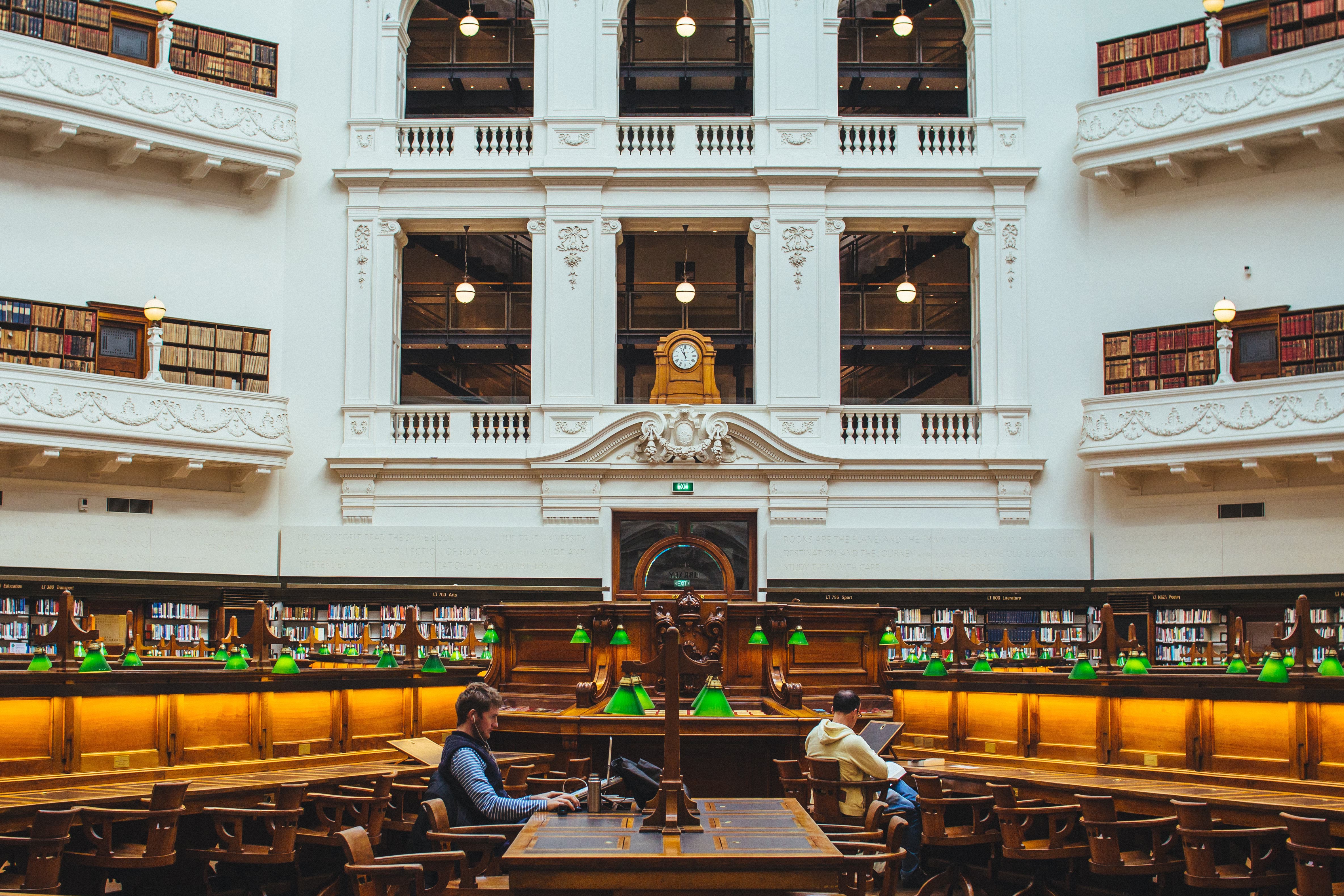 People using their laptops while sitting in the Victoria State Library