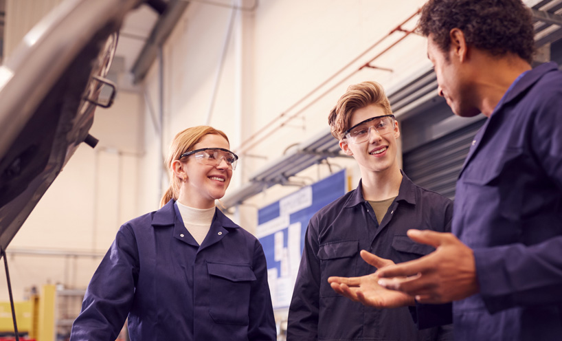 Two automotive apprentices and teacher