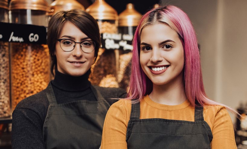 Two retail workers in a health food shop