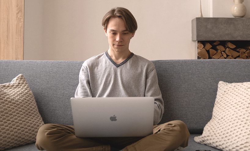 Person using laptop on couch