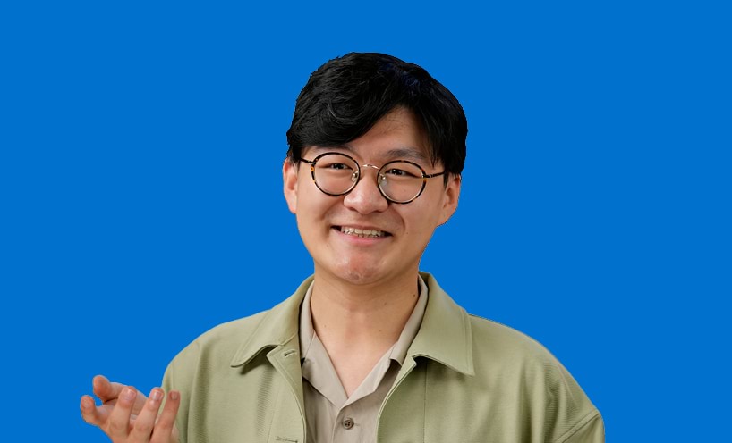 Image of male graduate in front of blue background 