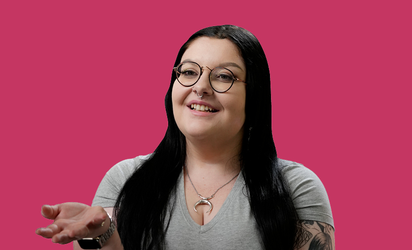 Image of female graduate with pink background behind her