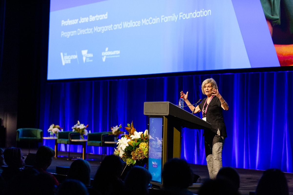 Professor Jane Bertrand lecturing on stage at the conference