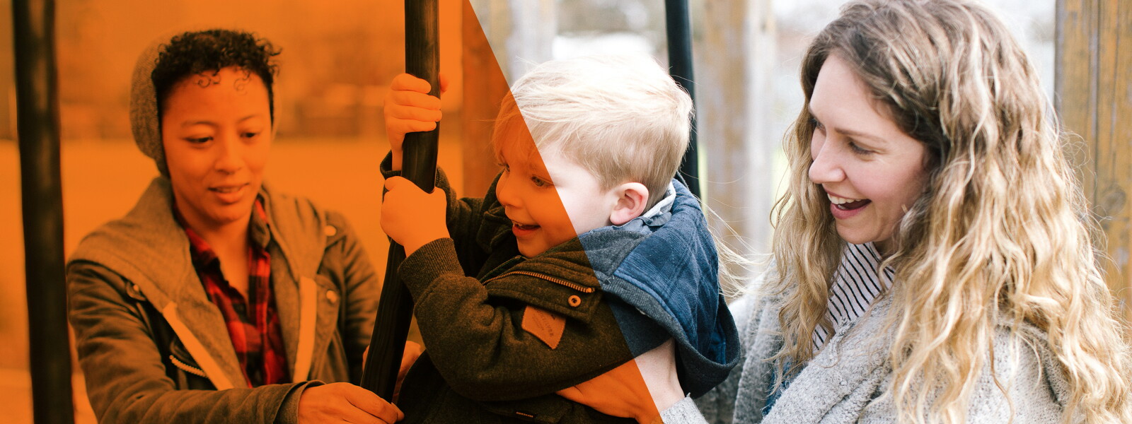 Two women with a child on playground equipment