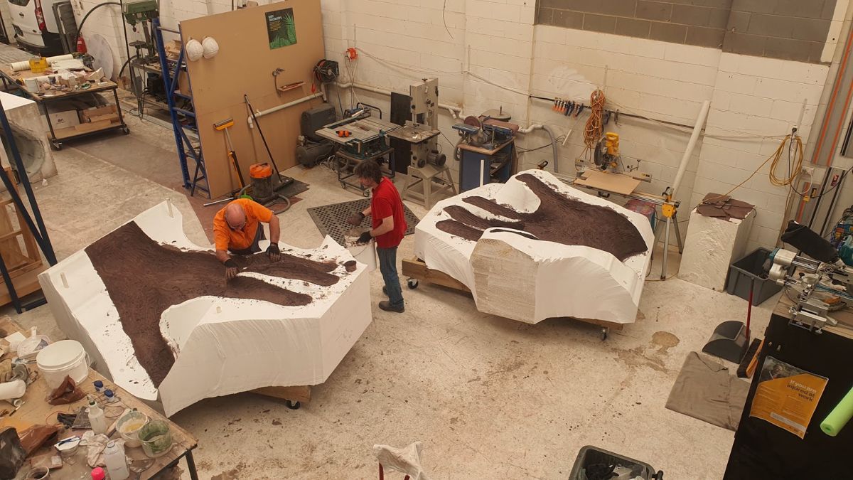 Artisans at the Aeroplane Workshop with the moulds of the giant hand in two parts.