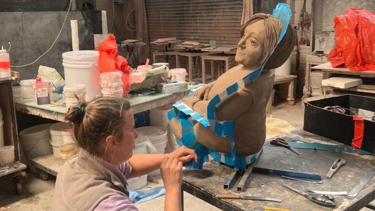 An artisan prepares the clay sculpture for creating the silicone moulding.