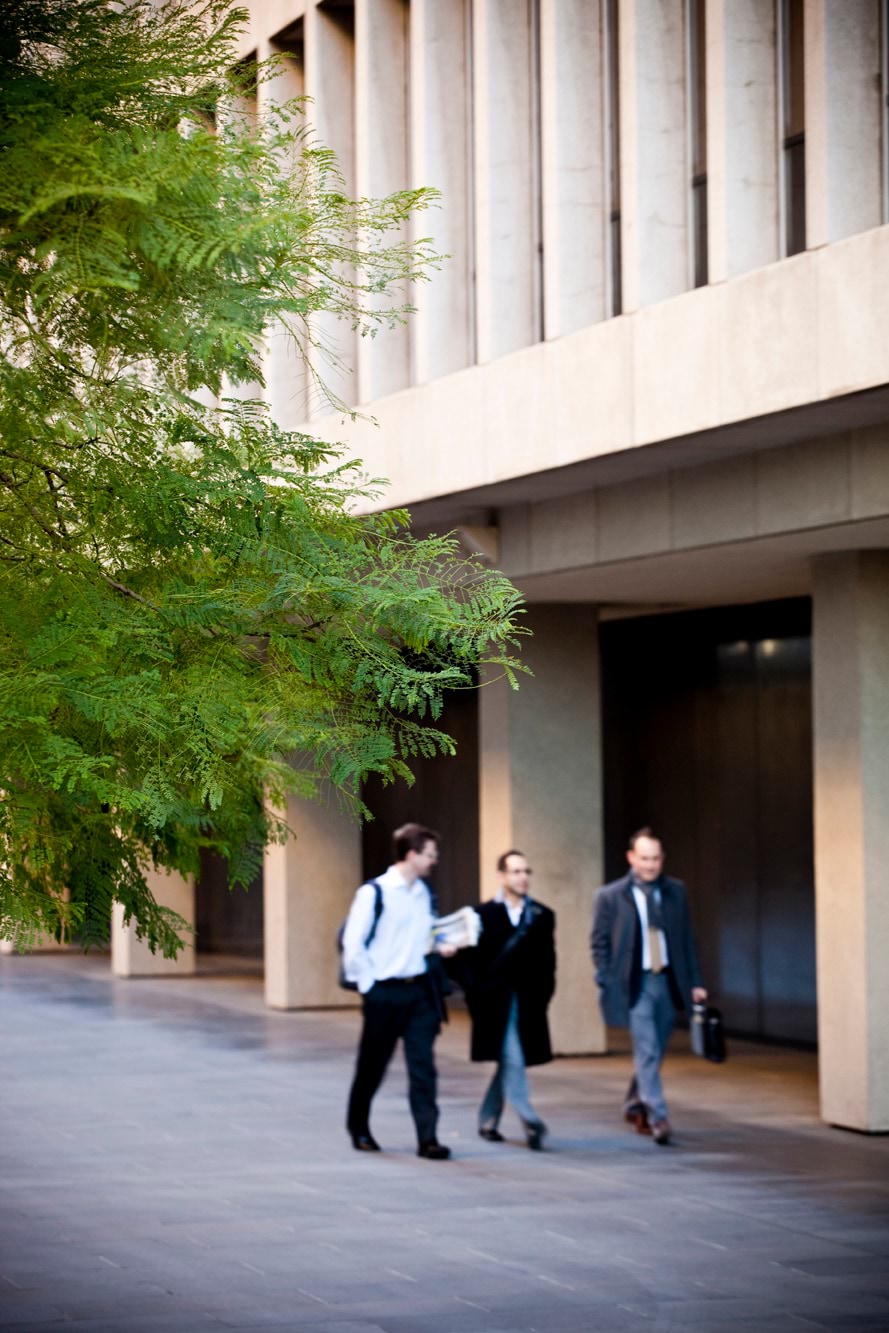 Image of three people walking in front of 1 Treasury place, Melbourne