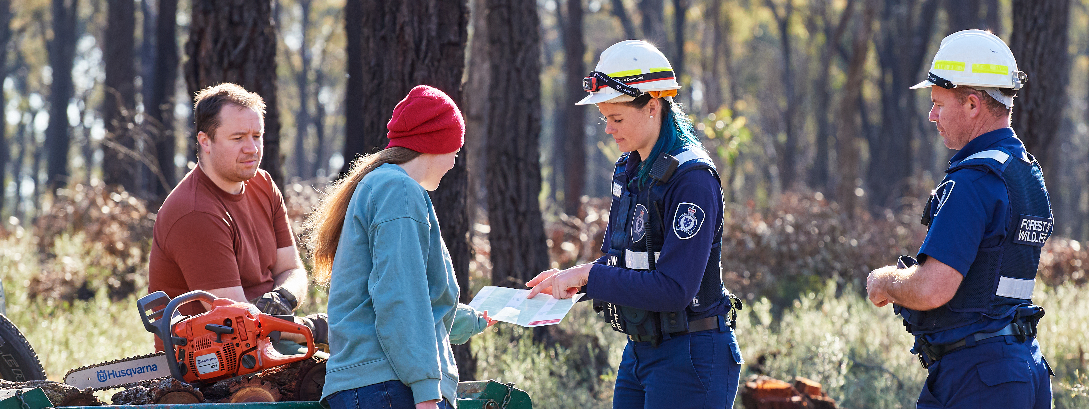 Photo of officers and people collecting firewood