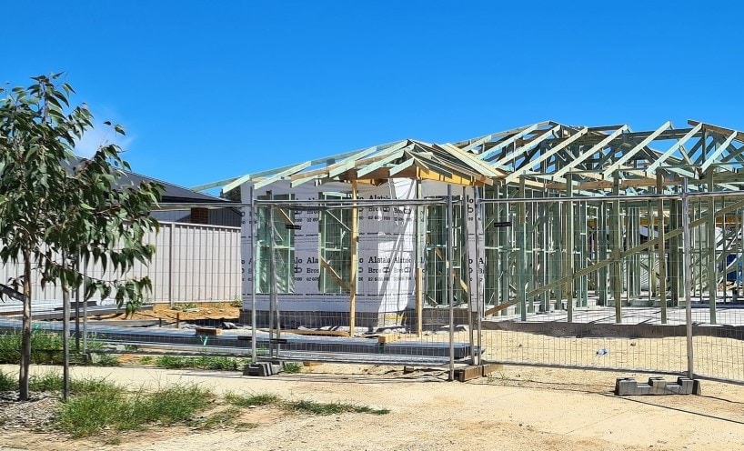 House under construction with temporary fencing