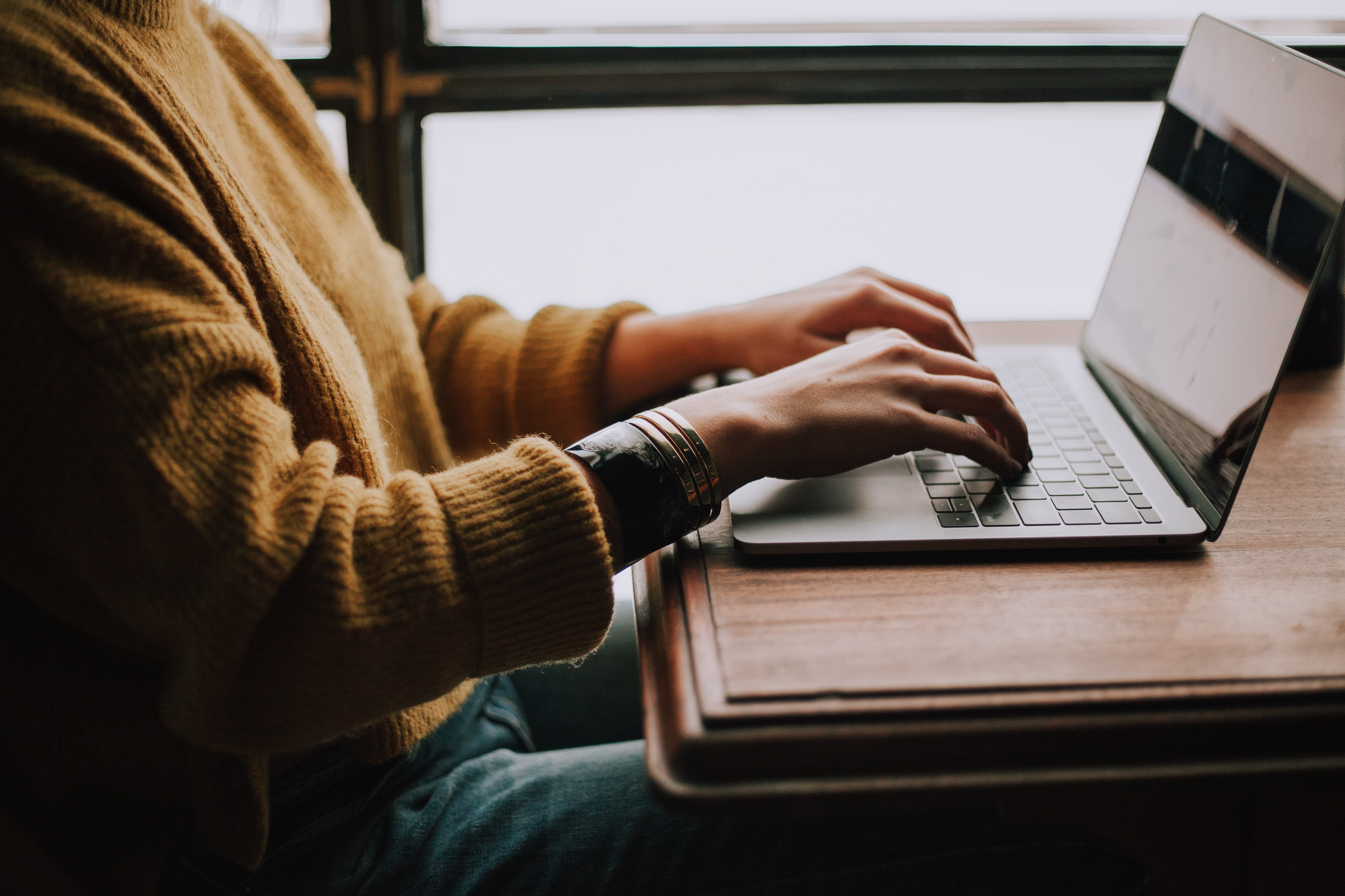 Hands on a laptop