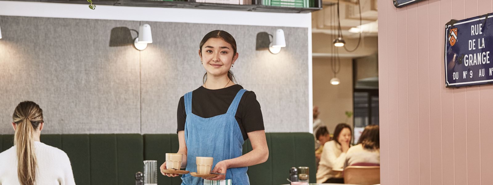 Sick Pay Guarantee - girl in coffee shop with a smile