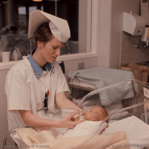 Nurse feeding baby in the nursery ward at Royal Women's Hospital in Melbourne