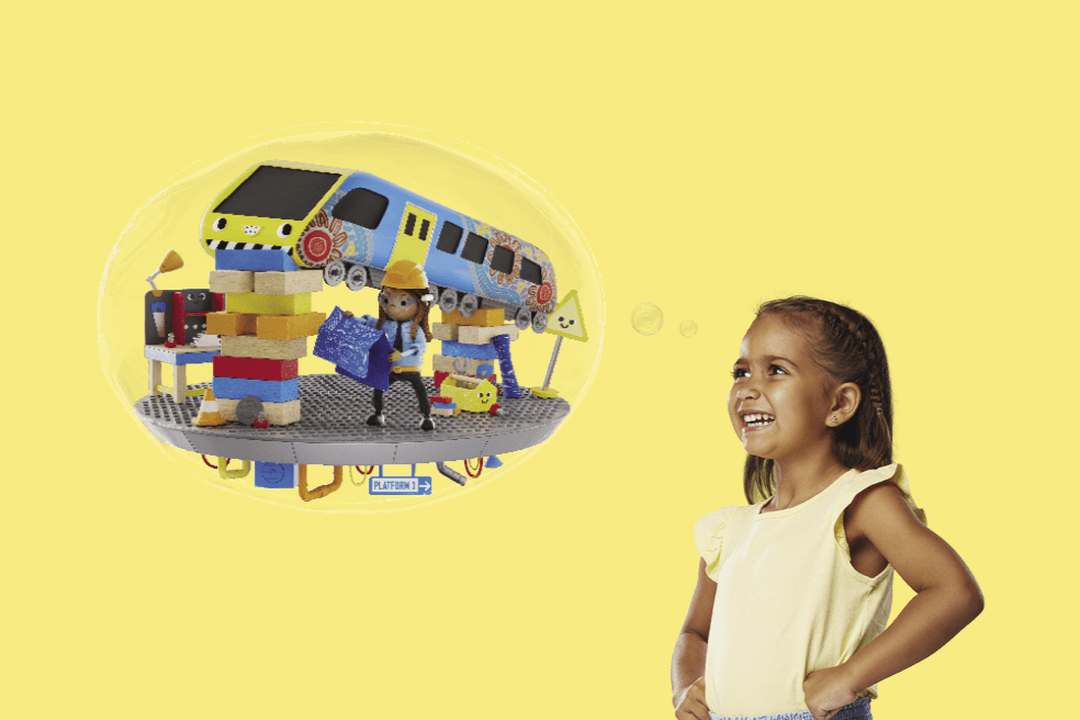 Young Koorie girl looks up at an imagination bubble and see herself as an engineer working on a train.