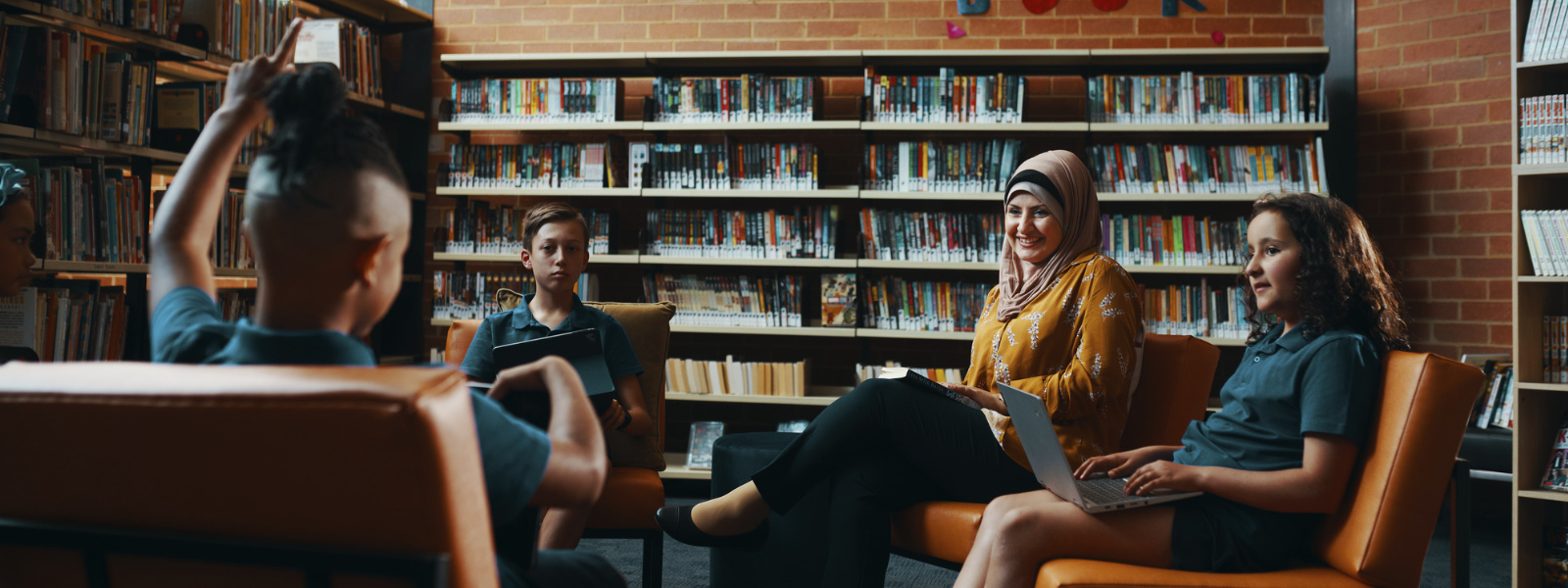 Teacher in library with students