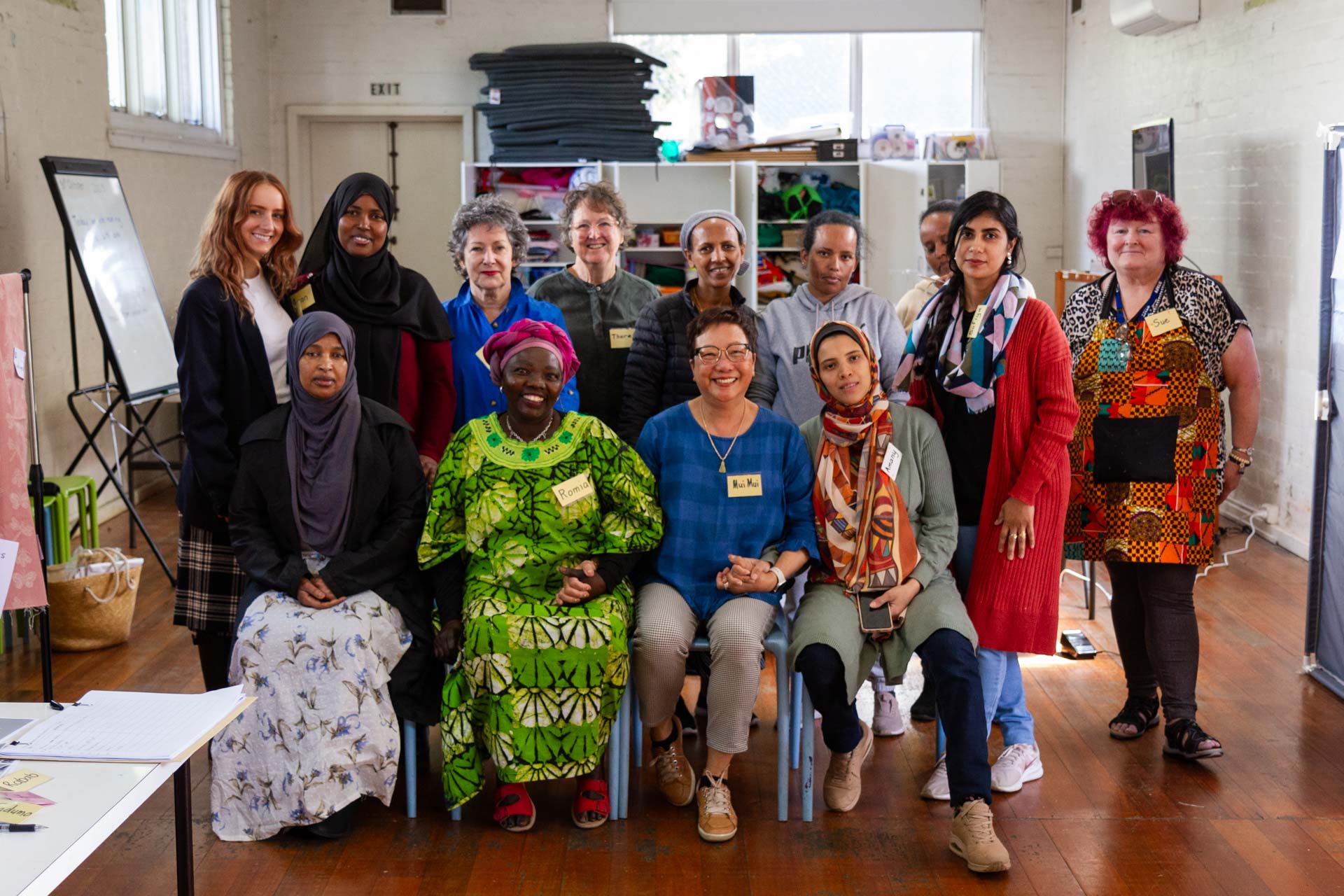 2023 Learn Local Awards winner Sew and Grow picture of 9 women standing back row and 4 women seated front row from Kensington Neighbourhood House Sew and Grow program