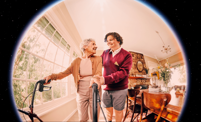 High school student helping to an elderly person walk with their walker