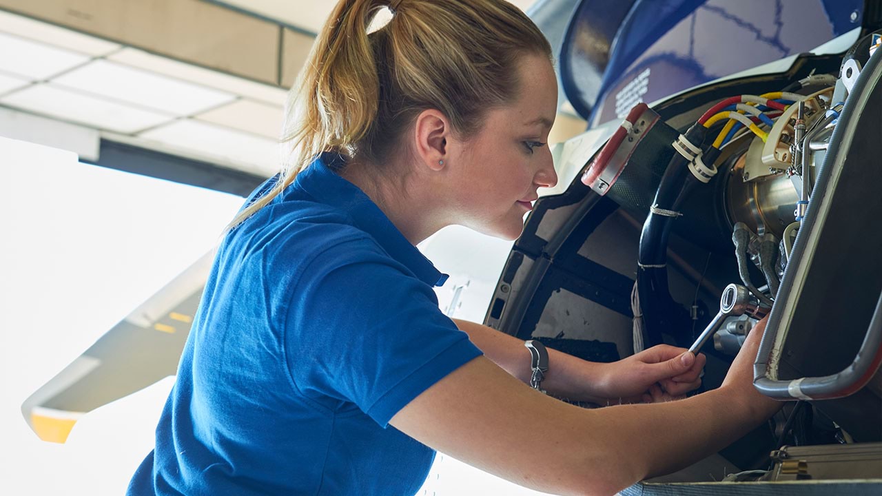 Technician working on aircraft engine