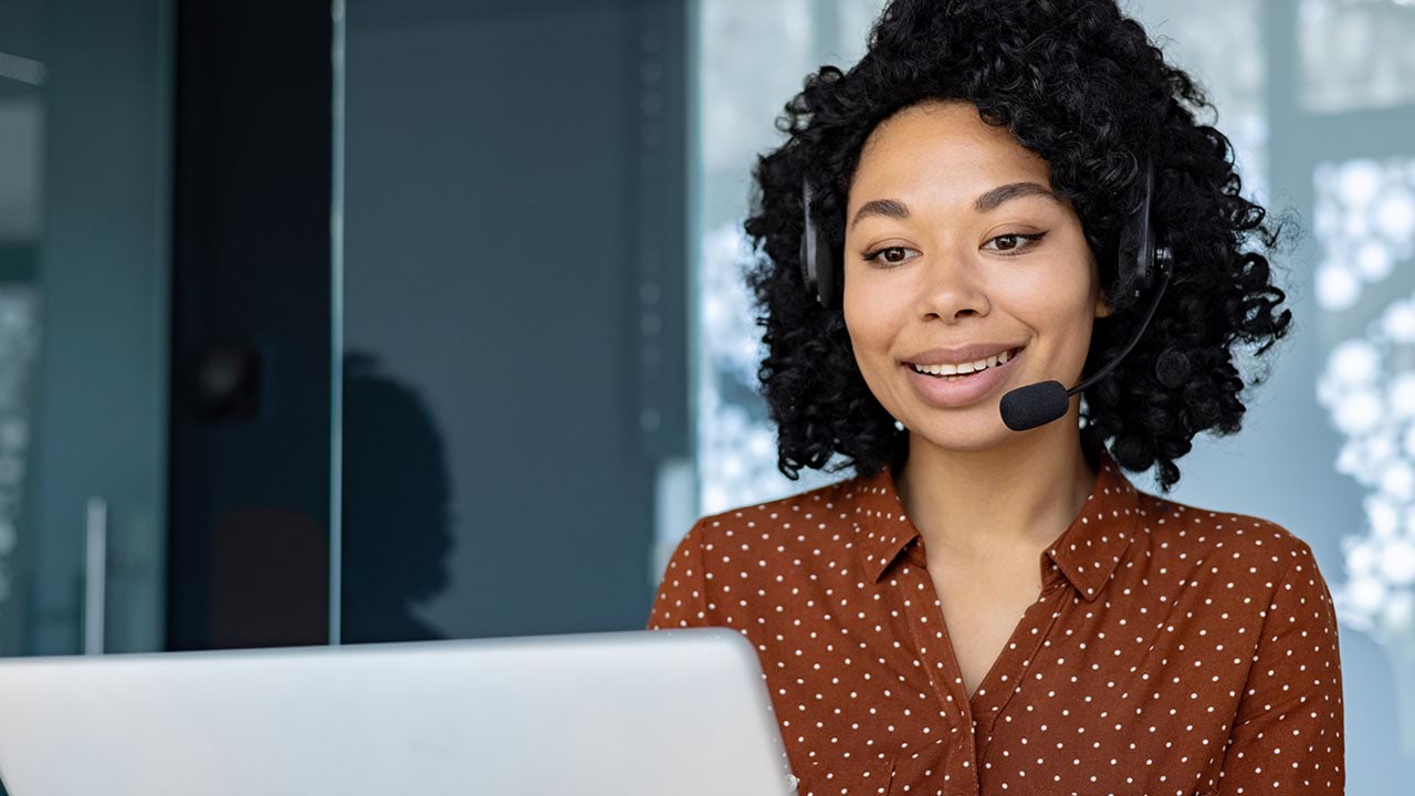 Person wearing headset working on a computer