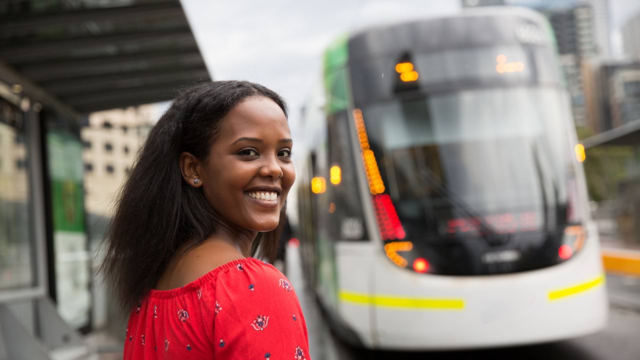 Person standing near tram