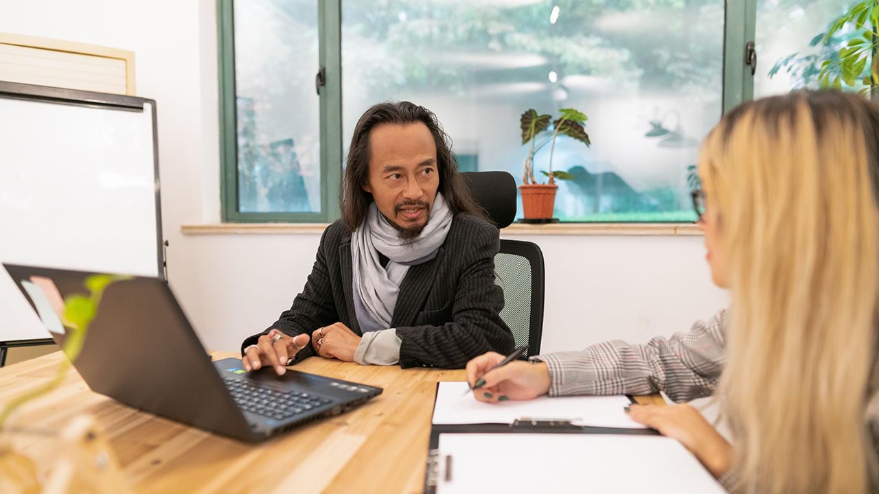 Two people in front of laptop