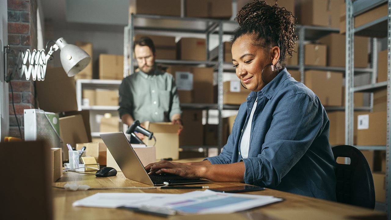 Two people working in a warehouse setting