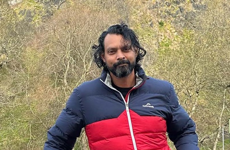 Researcher Rohit Gupta in front of trees