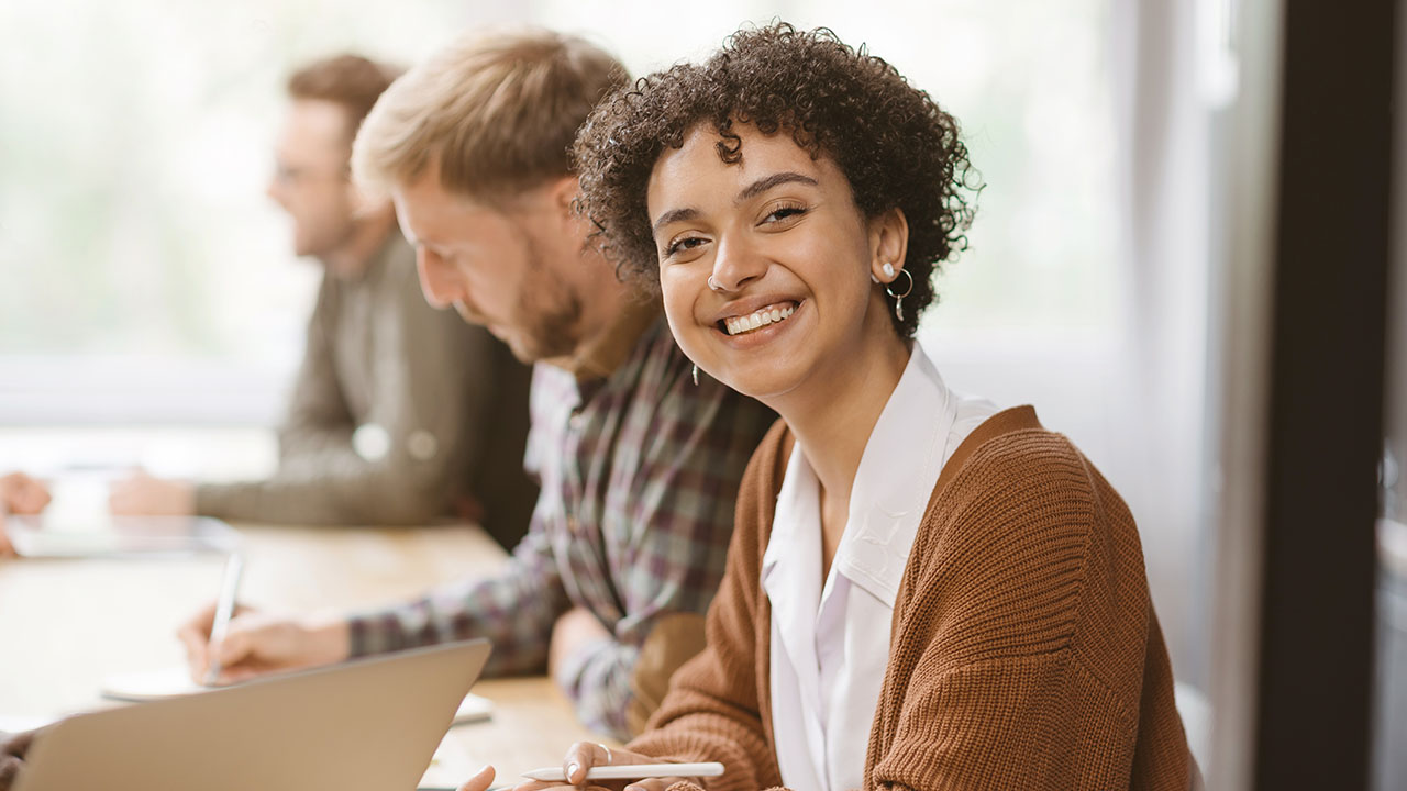 Person smiling into the camera in adult class setting