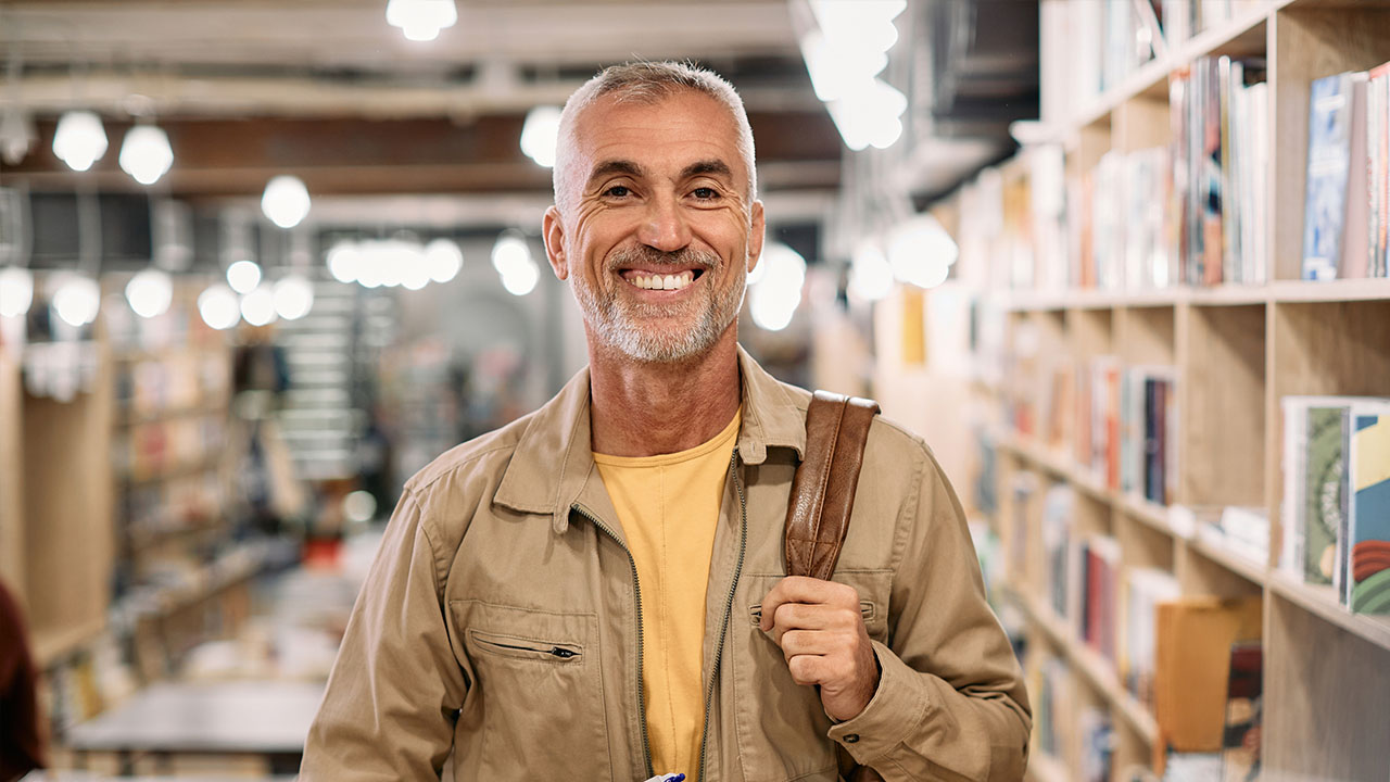 Person looking into the camera in a library setting