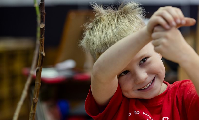 A boy in a red t-shirt smiling .