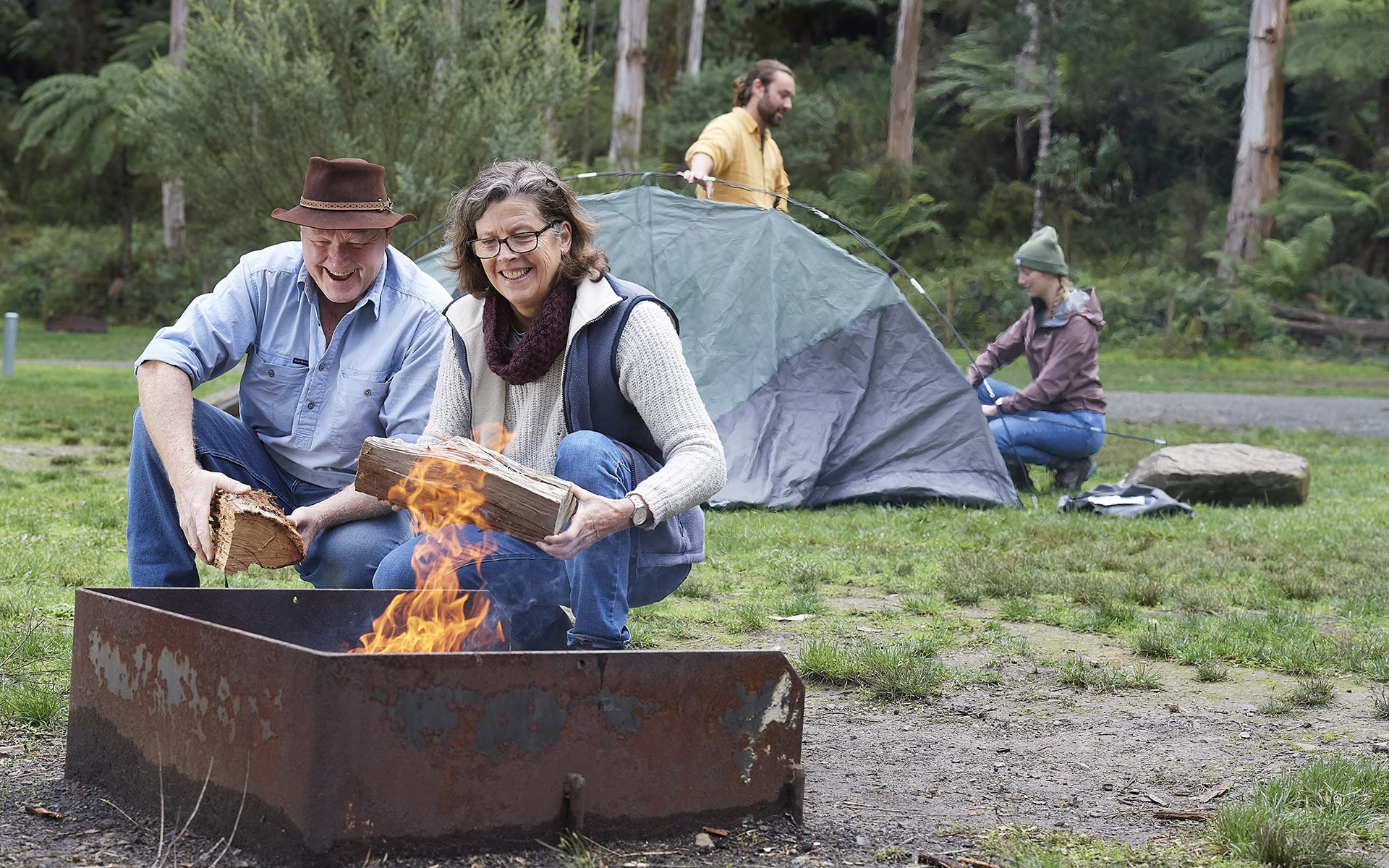 Campers building campfire