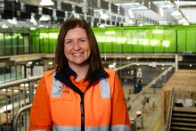 Person wearing hi vis standing in a factory smiling