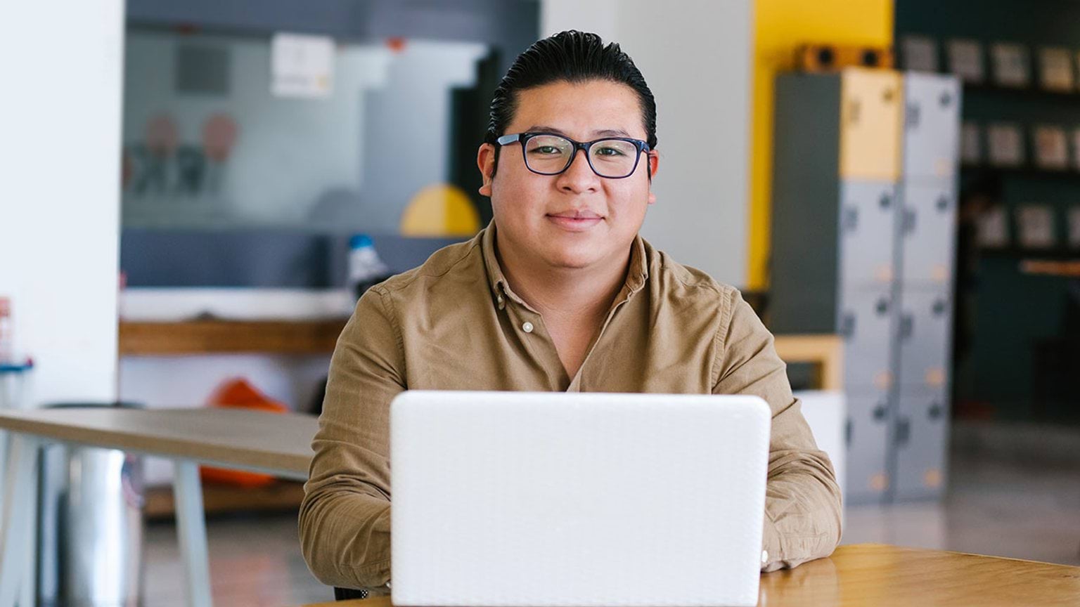 Person using a computer, looking at the camera