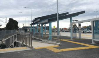 A photo of Huntingdale station bus interchange with a ramp and stairs next to each other.