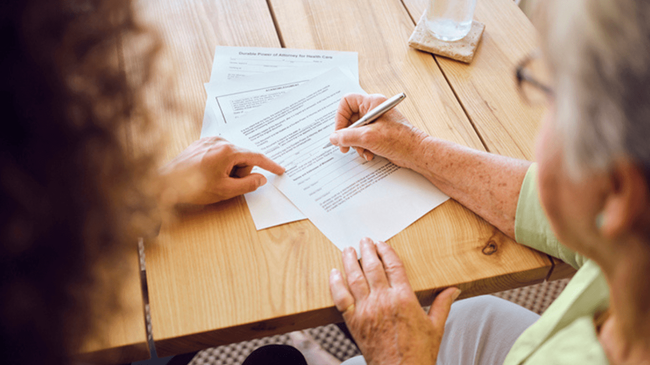 Two people filling out a form together