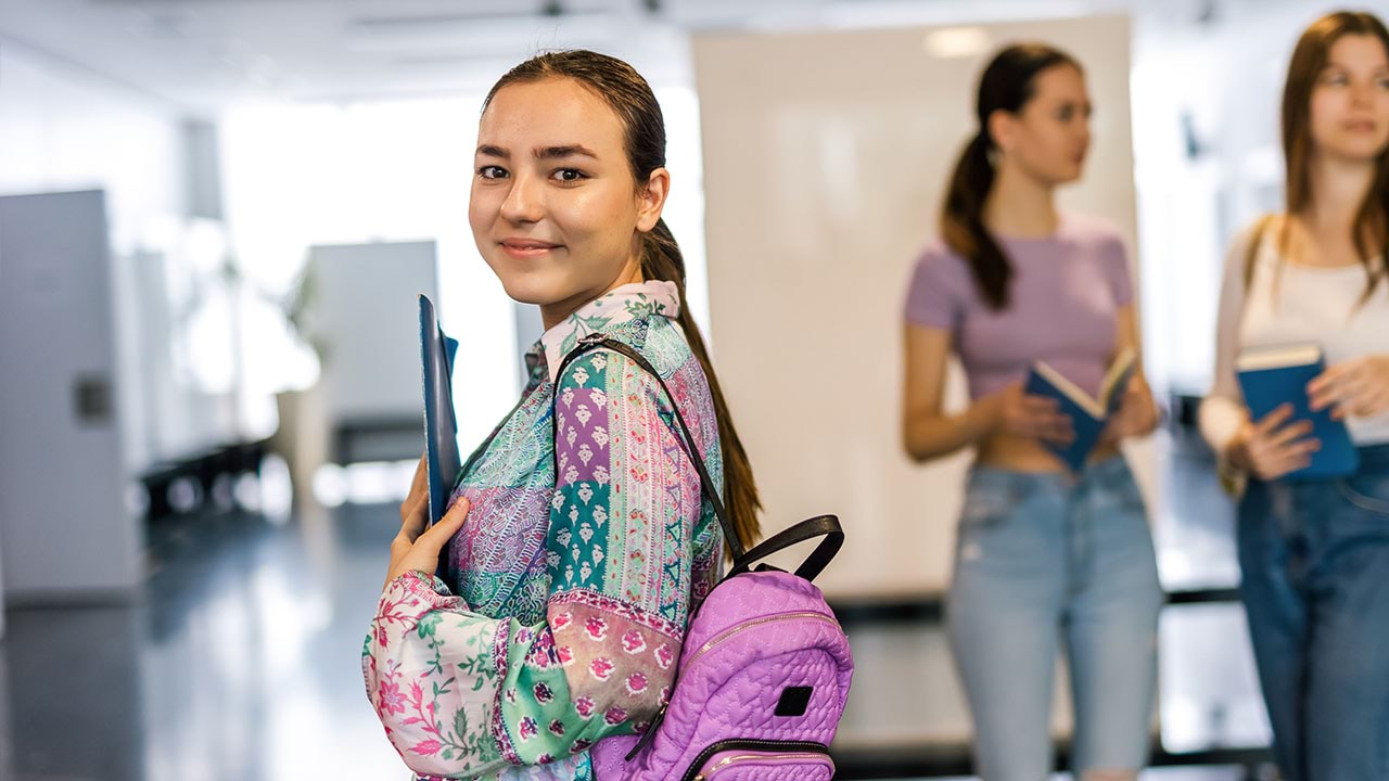 Student looking at camera with other students in the background