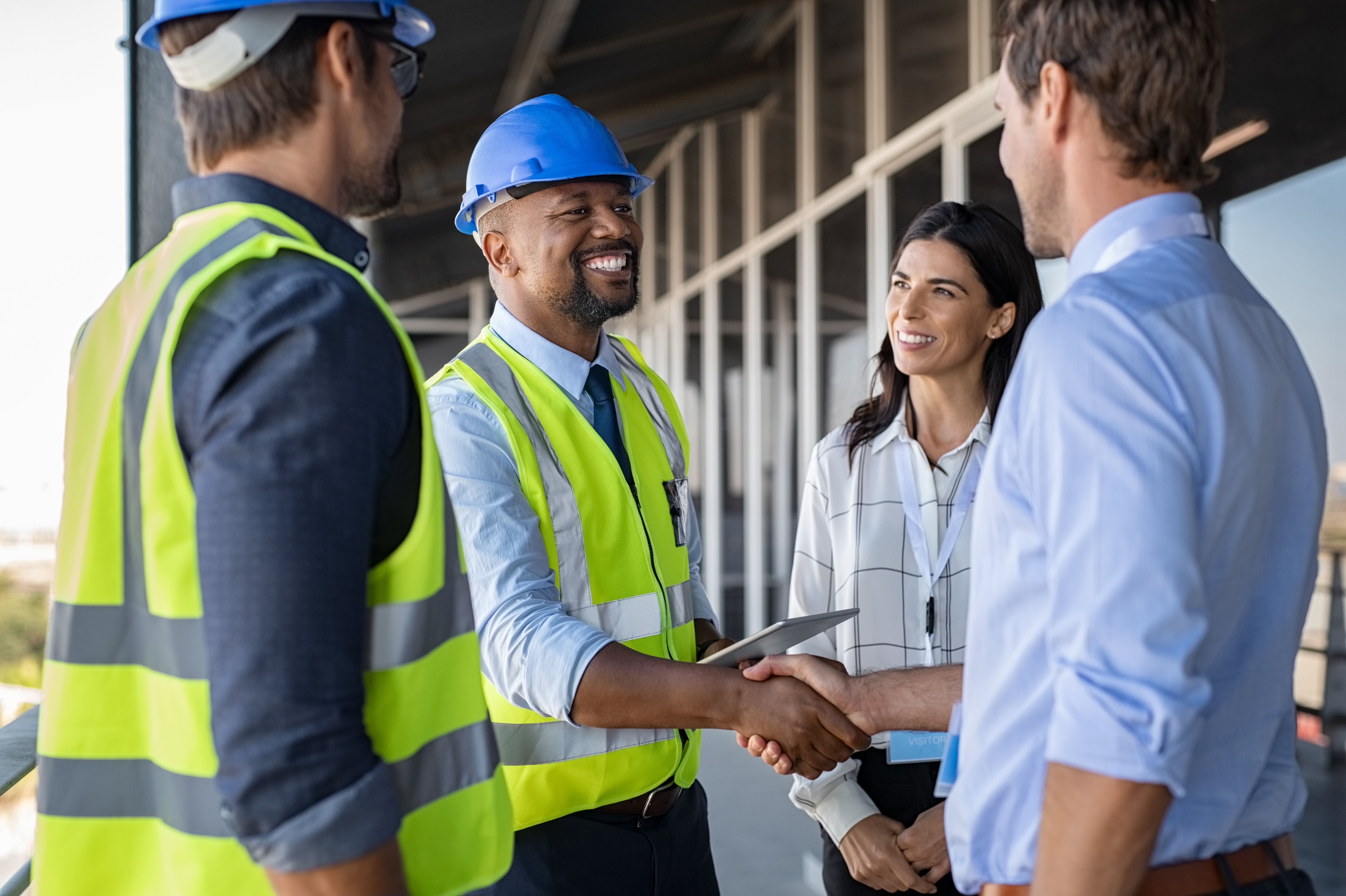 Four people, two of which are shaking hands