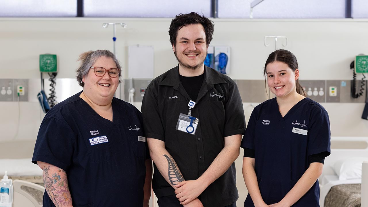 Two nursing students with trainer