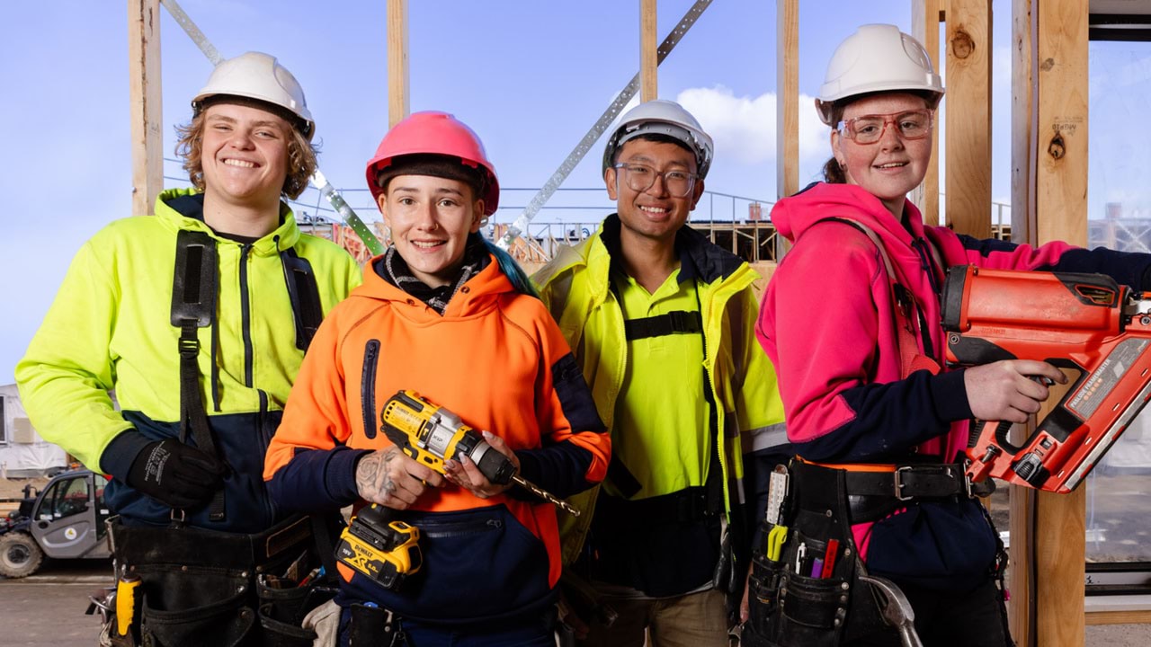 Four trade workers looking at the camera