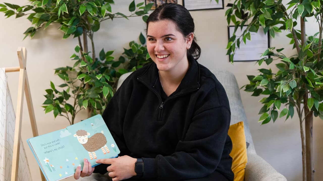 Early childhood teacher reading a story